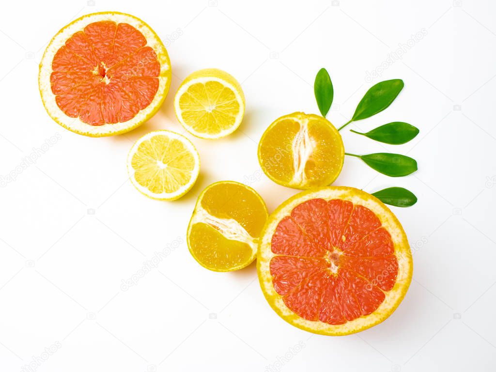 Halves of fresh ripe citrus fruits on white background