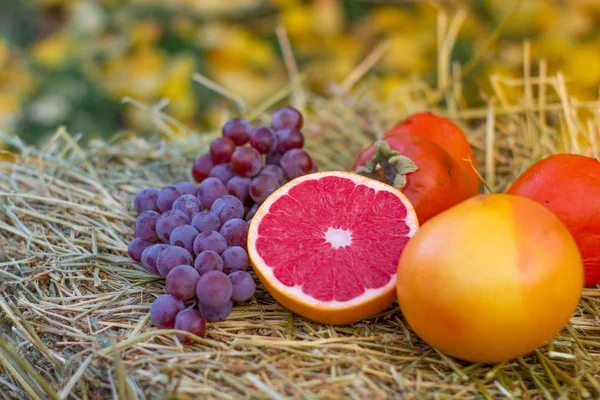 stock image Delicious fresh fruits on haystack, close up view