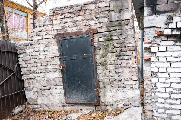 collapsing brick building with doors