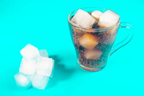 black carbonated drink with ice cubes, cold cocktail