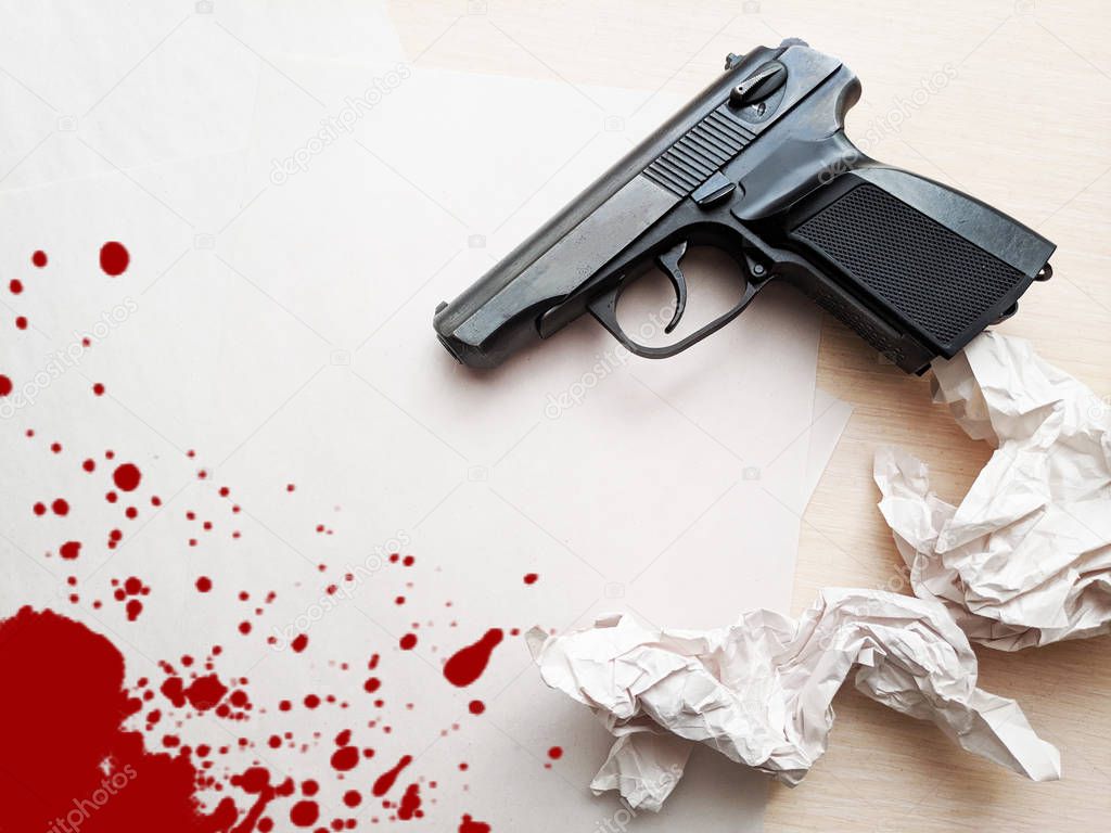 gun on the table, gun and paper, blood on paper and gun