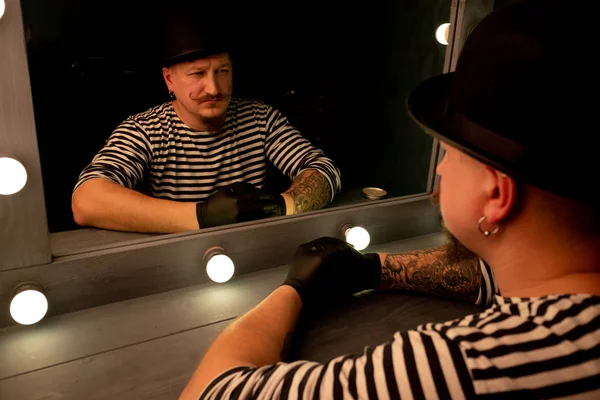 reflection in the mirror man, portrait of a man in a hat with a mustache and beard