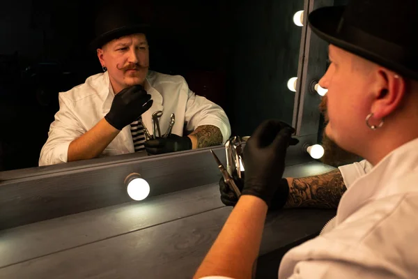 reflection in the mirror man, portrait of a man in a hat with a mustache and beard