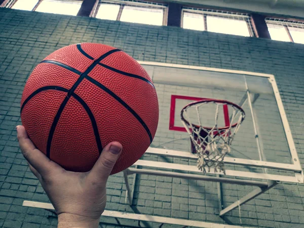 Basketball. Basketball court. Hand holding ball