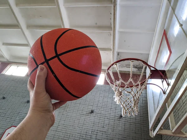 Basketball. Basketball court. Hand holding ball
