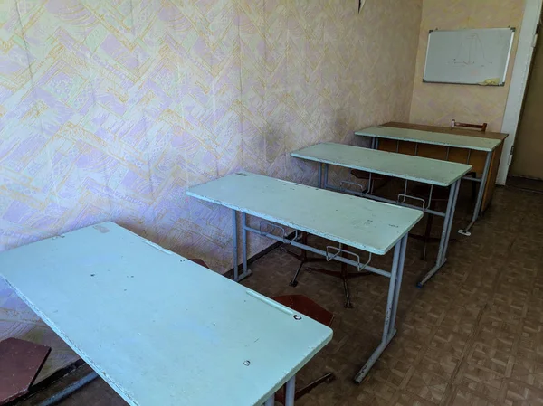 vintage tables and chairs. old classroom. lecture hall. student audience. antique desks