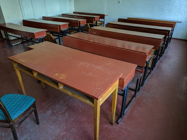 vintage tables and chairs. old classroom. lecture hall. student audience. antique desks