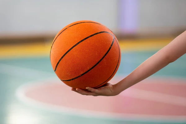 ball for basketball in hand. sport. basketball court and ring. sport game. healthy lifestyle.