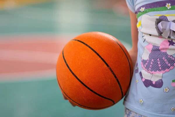 ball for basketball in hand. sport. basketball court and ring. sport game. healthy lifestyle.