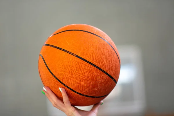 ball for basketball in hand. sport. basketball court and ring. sport game. healthy lifestyle.