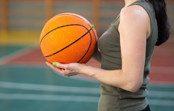 ball for basketball in hand. sport. basketball court and ring. sport game. healthy lifestyle.