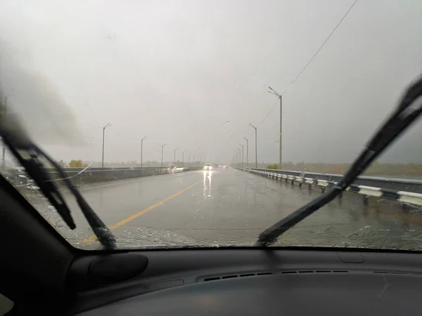 driving a car in the rain. rain and bad weather. wet road