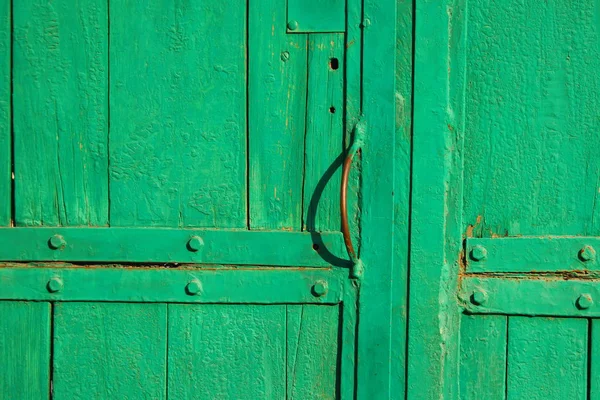 old wooden gate. old boards of green color. wood texture