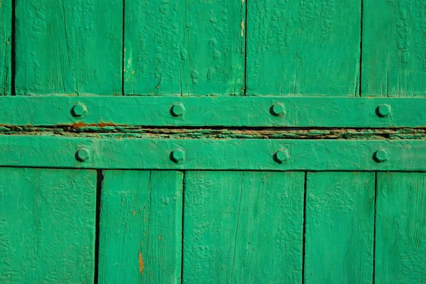 old wooden gate. old boards of green color. wood texture