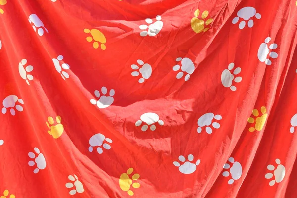 red background with paw prints. colored paw prints. abstract red background