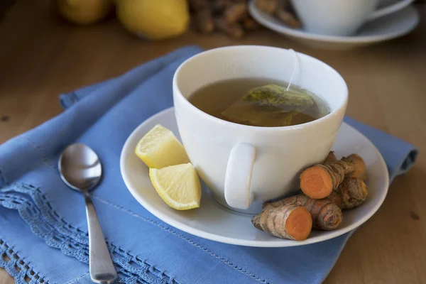 Healthy cup of hot turmeric tea with lemon
