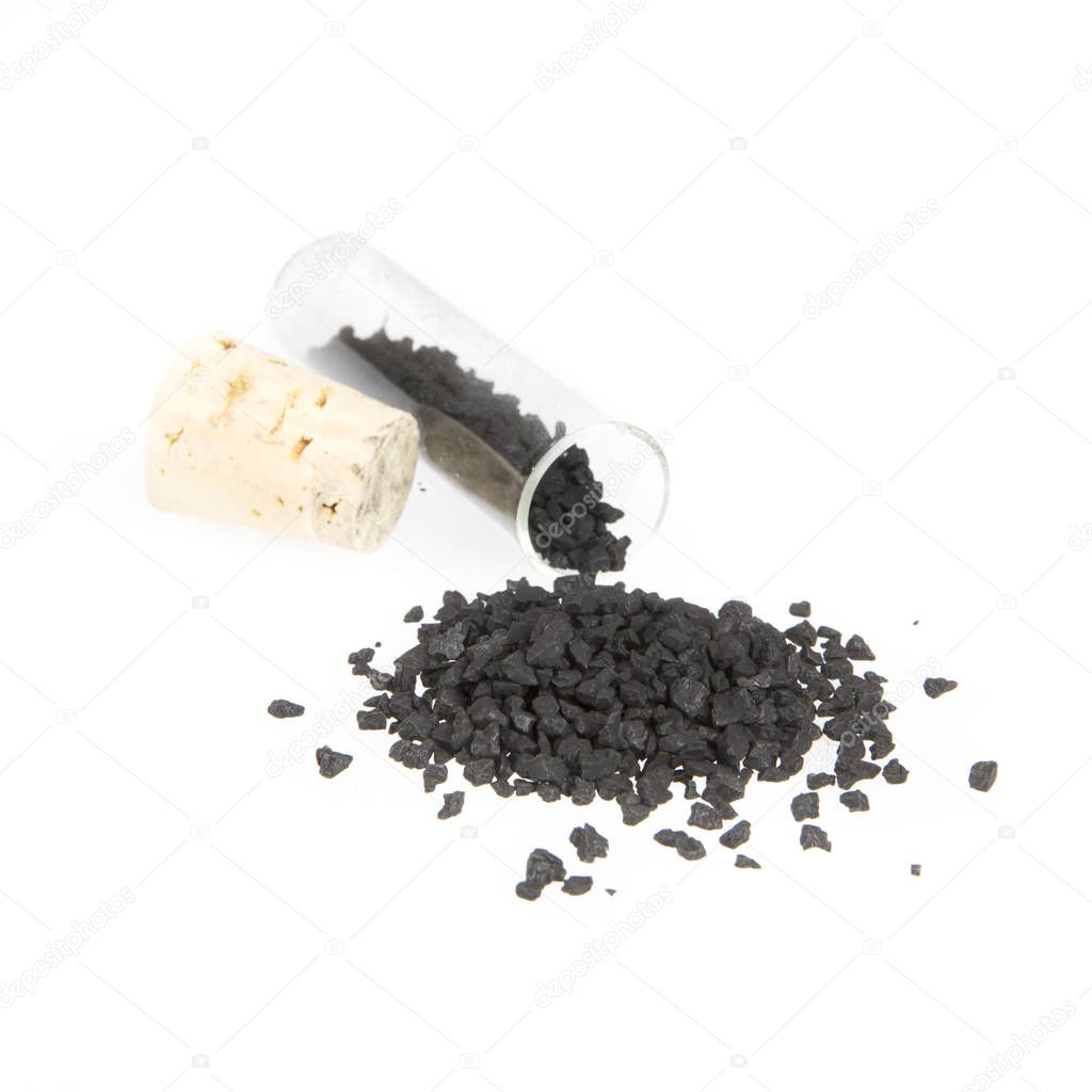 Black Hawaiian sea salt with corked glass jar isolated on white.