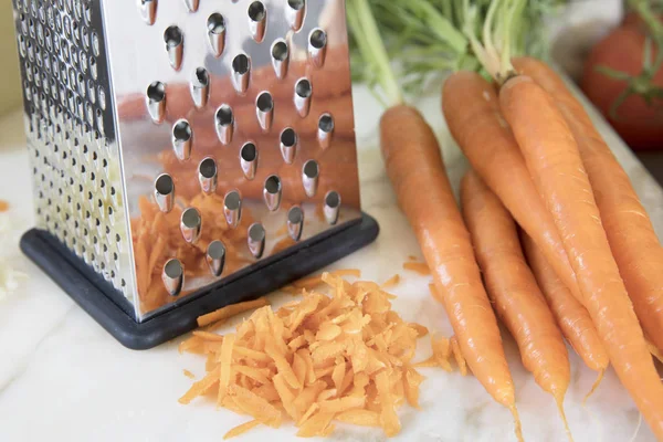 Cheese Grater and Shredded Carrots
