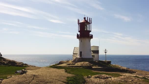 Video of Lindesnes beacon in summer, South Norway. Aerial shot. Rocky sea coast and blue sky. — Stock Video