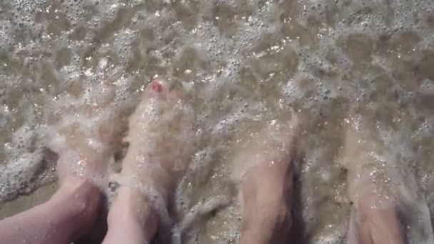 Girl and man legs in the ocean. slow motion video — Stock Video