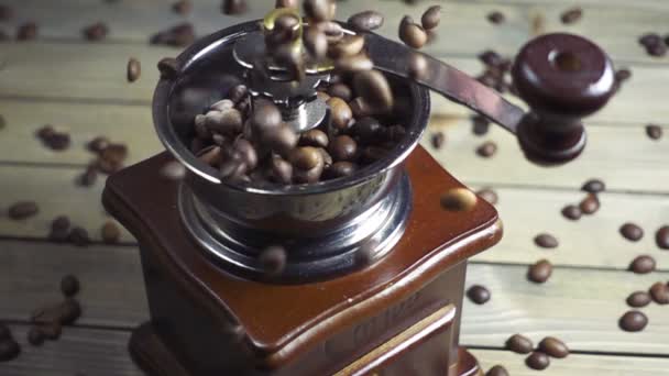 Pouring coffee beans into wooden vintage grinder, slow motion — Stock Video
