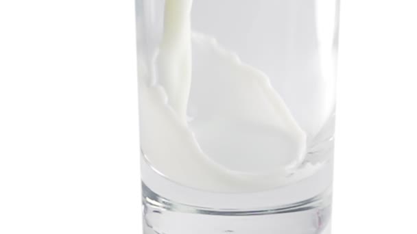 Молоко выливается в стекло в замедленной съемке — стоковое видео
