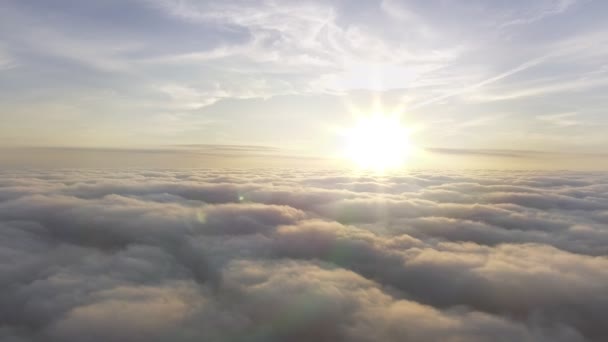 Aerial view above the clouds towards the sun — Stock Video