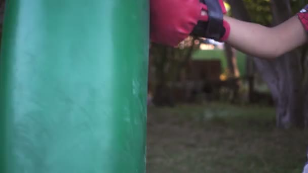 Boxer punching bag, on the outdoor. Slow motion sequence. — Stock Video