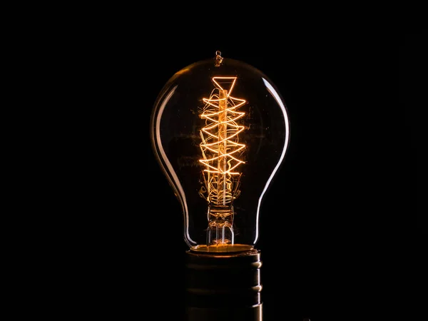 Edisons light bulb illuminates from electric current — Stock Photo, Image