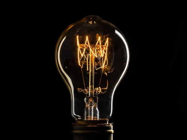 Edisons light bulb illuminates from electric current — Stock Photo, Image