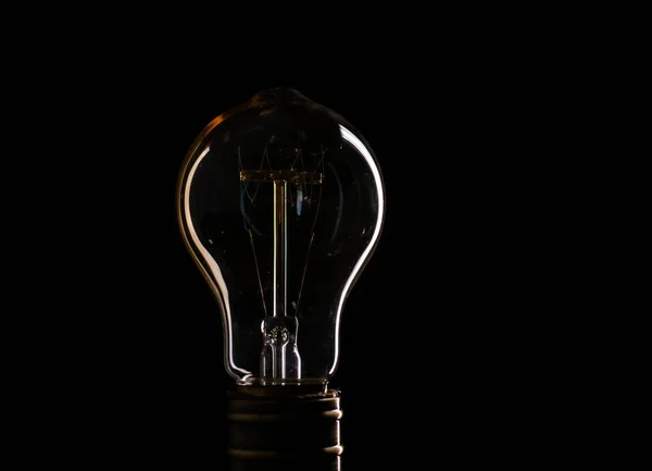 Edisons light bulb illuminates from electric current — Stock Photo, Image