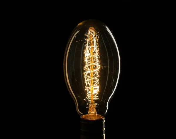 Edisons light bulb illuminates from electric current — Stock Photo, Image