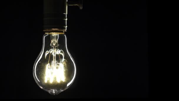Edisons light bulb illuminates slowly from electric current — Stock Video