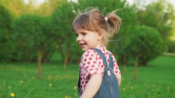 Cute little girl fun running on sunny summer day in park, slow motion — Stock Video