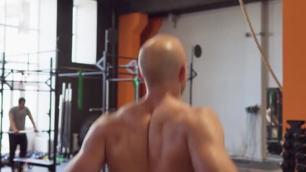 Фитнесмен занимается прыжками через скакалку в спортзале — стоковое видео