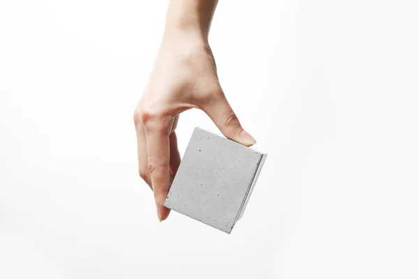 A womans hand holds a box made of concrete — Stock Photo, Image