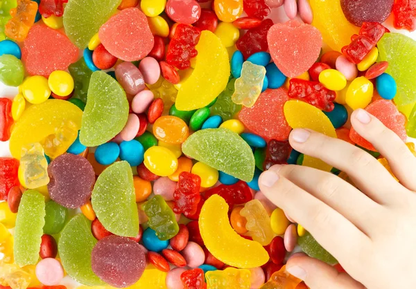 Child Hand Reaches Sweets Candy Background — Stock Photo, Image