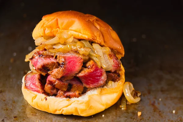 玉ねぎと素朴なステーキ サンドイッチのクローズ アップ — ストック写真