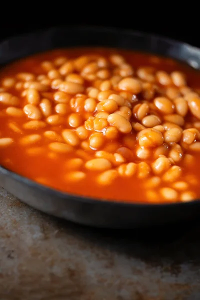 close up of rustic english baked beans in tomato sauce