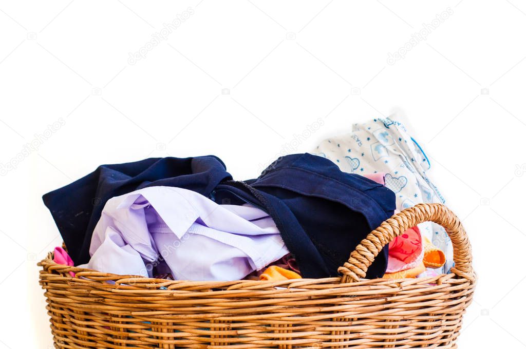 different clothes in wooden basket isolated on white background 