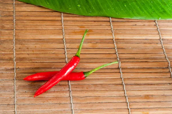 Close Peppers Lying Banana Leaf Wooden Background — Stock Photo, Image