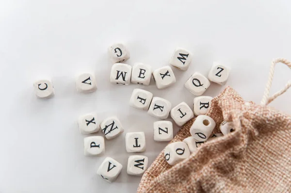 Letters Dobbelstenen Buurt Van Zak Witte Achtergrond — Stockfoto