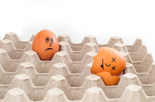 eggs with funny faces in corrugated packaging