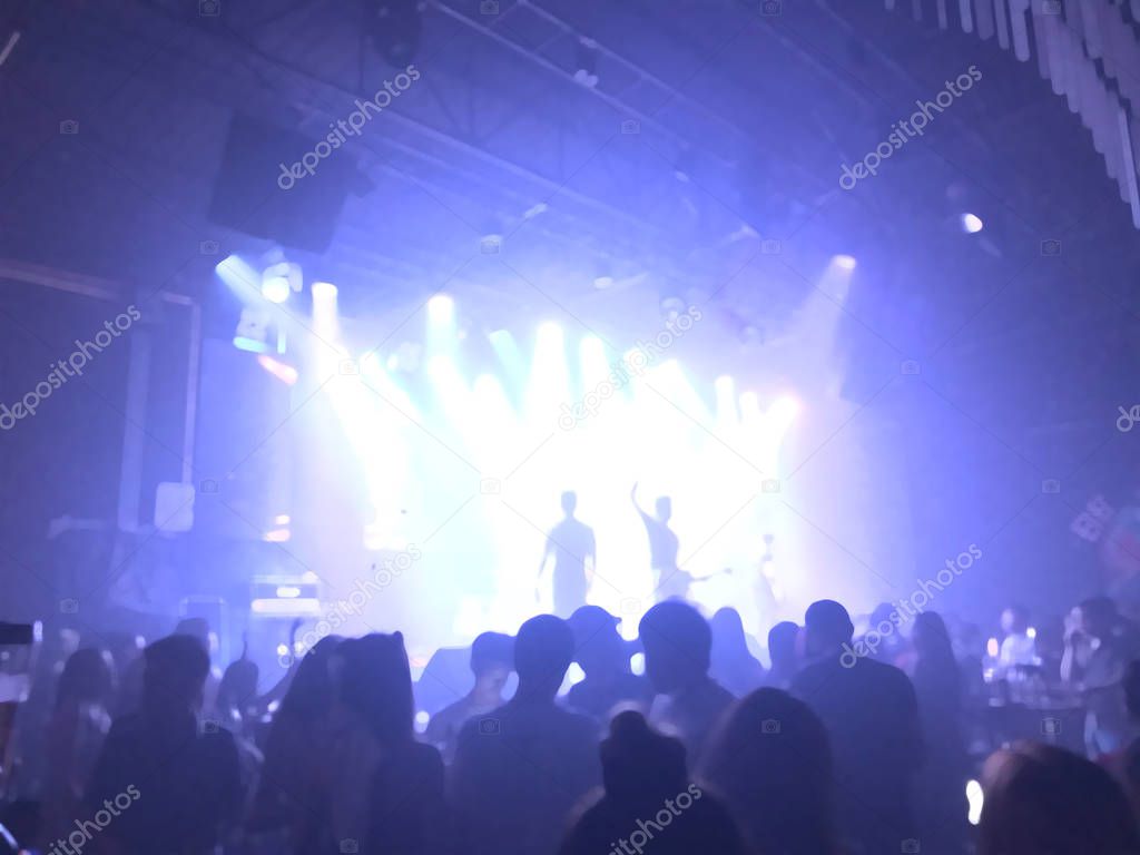 group concert in hall with projectors lighting