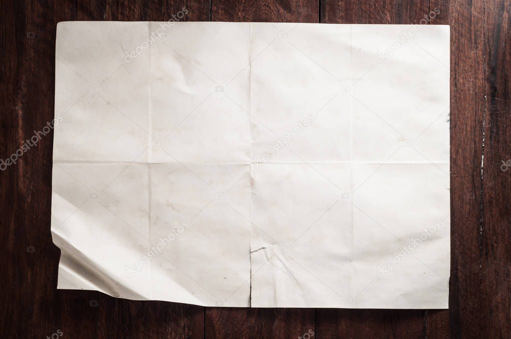 empty aged paper sheet on wooden background