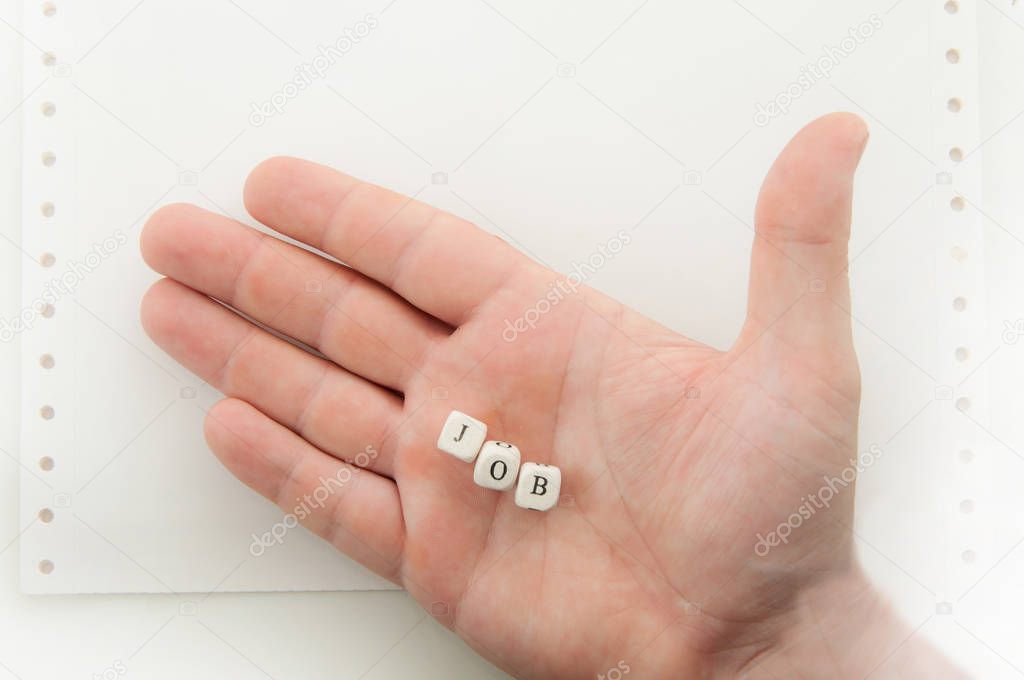 male hand holding dices with word job