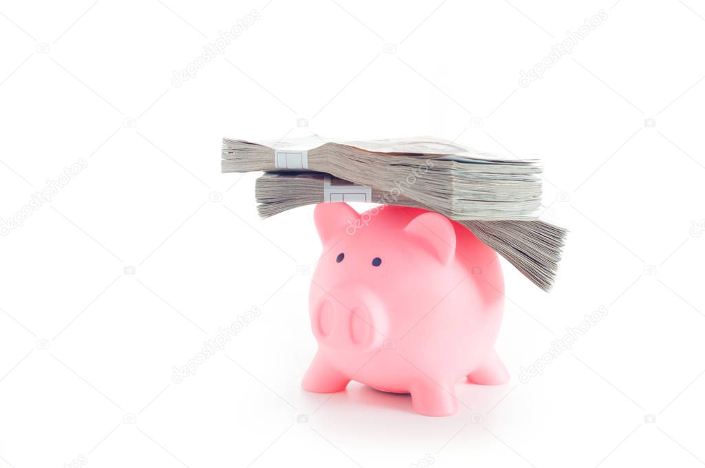 pink piggy bank with stack of money on white background