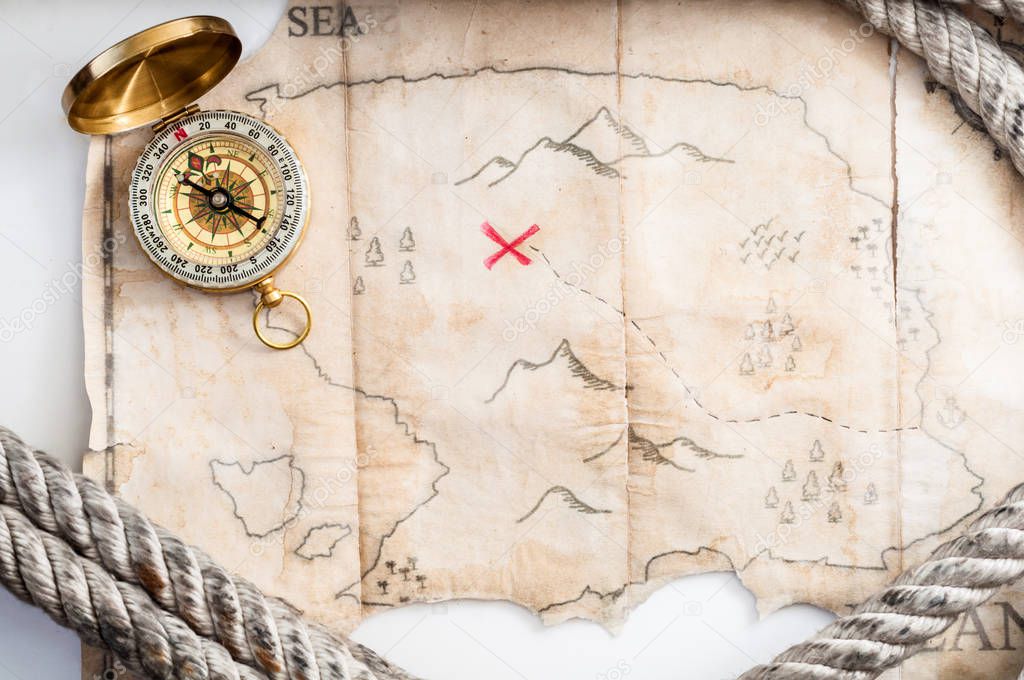Compass and map of island with treasure sign 