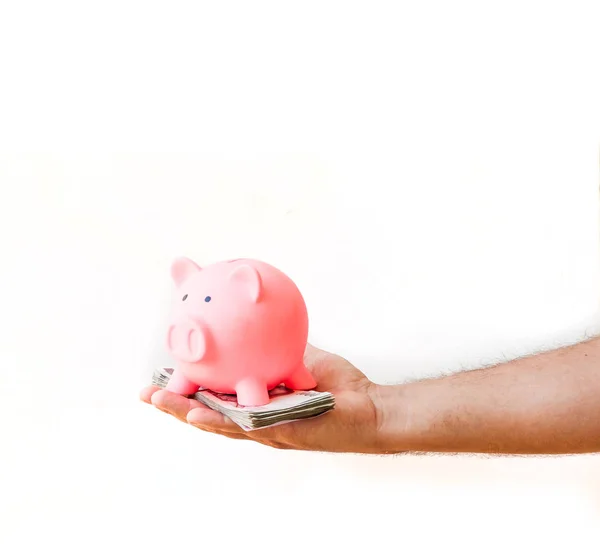 Mão Masculina Segurando Pilha Dinheiro Com Banco Porquinho Fundo Branco — Fotografia de Stock