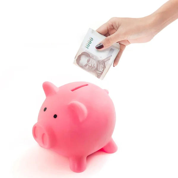 Mano Femenina Poniendo Dinero Efectivo Alcancía Rosa Sobre Fondo Blanco — Foto de Stock